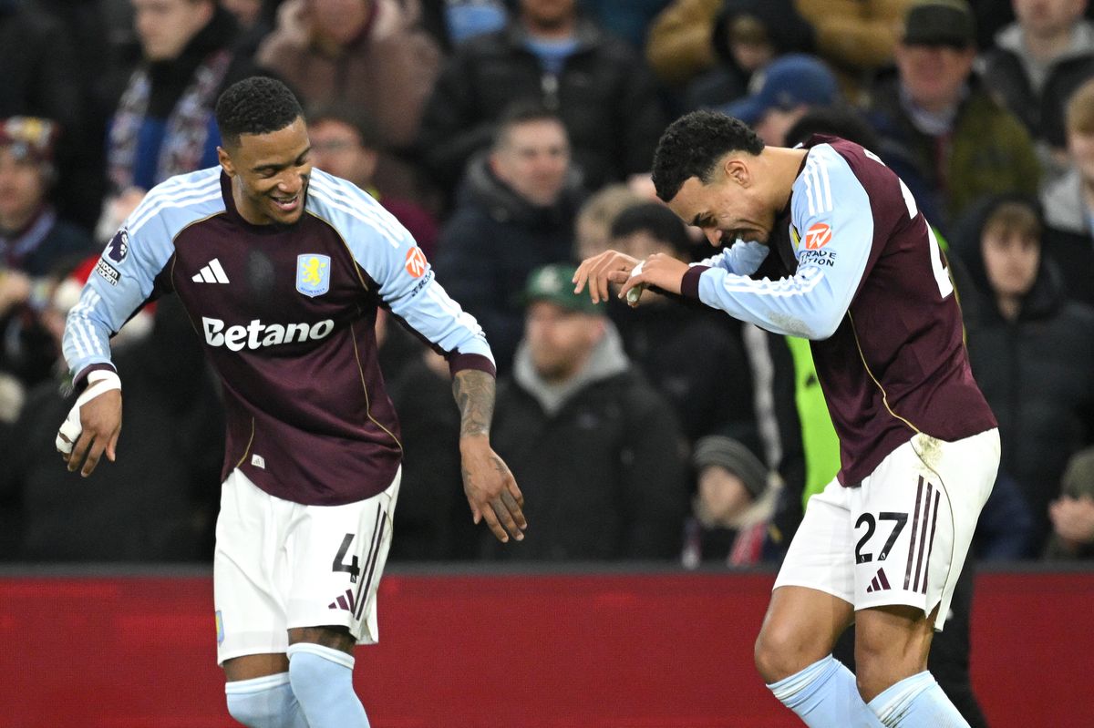 Morgan Rogers of Aston Villa celebrates scoring his team's first goal with teammate Ezri Konsa during the Premier League match between Aston Villa and Manchester United at Villa Park