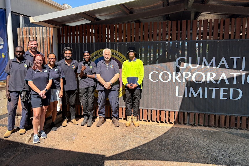 A group of people pose for a photo outside the Gumatj Corporation.