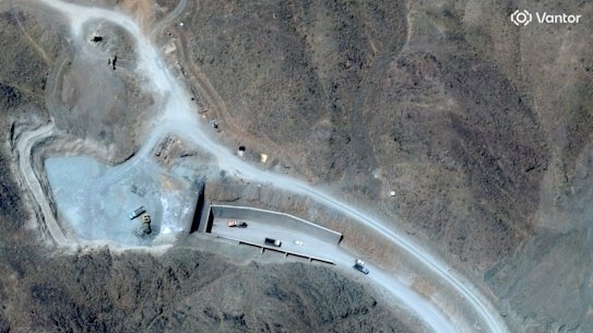 A satellite image shows vehicles at the western tunnel entrance to Iran’s secretive Pickaxe Mountain complex.