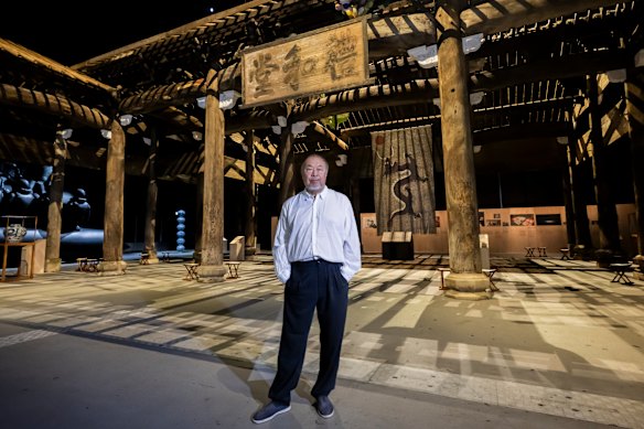 Ai Weiwei poses beside his work Wang Family Ancestral Hall at the exhibition Buttons Up! this month.
