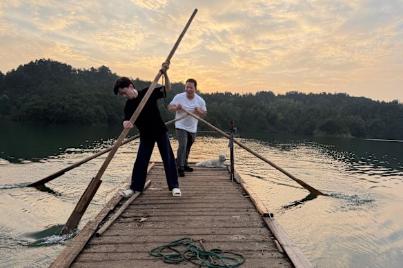 Li Zhiying and his friend, Li Mi, paddling on the reservoir that sustains the local village.