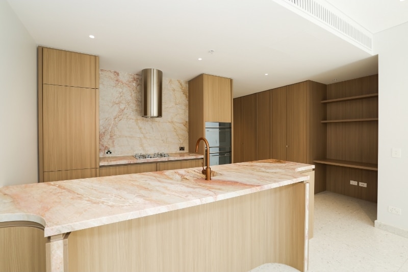 A real estate listings photo shows the kitchen of a new luxury apartment.