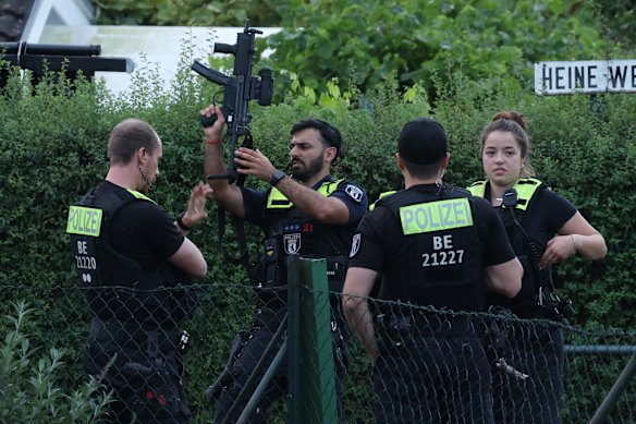 Police stand in a garden house colony in Berlin’s Spandau district, where authorities said the suspect in the deadly Berlin Pride van attack was shot dead in a confrontation on Sunday.