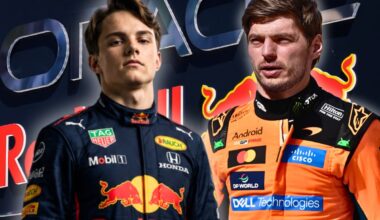 Piastri in navy Red Bull race suit next to Verstappen in papaya McLaren race suit with Red Bull Racing sign and logo as background