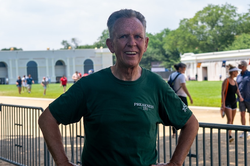 John Hess stands in front of portable metal fencing on the National Mall.