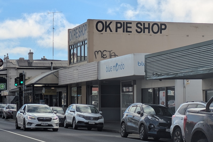 A shop on a main street with a sign saying OK PIE SHOP