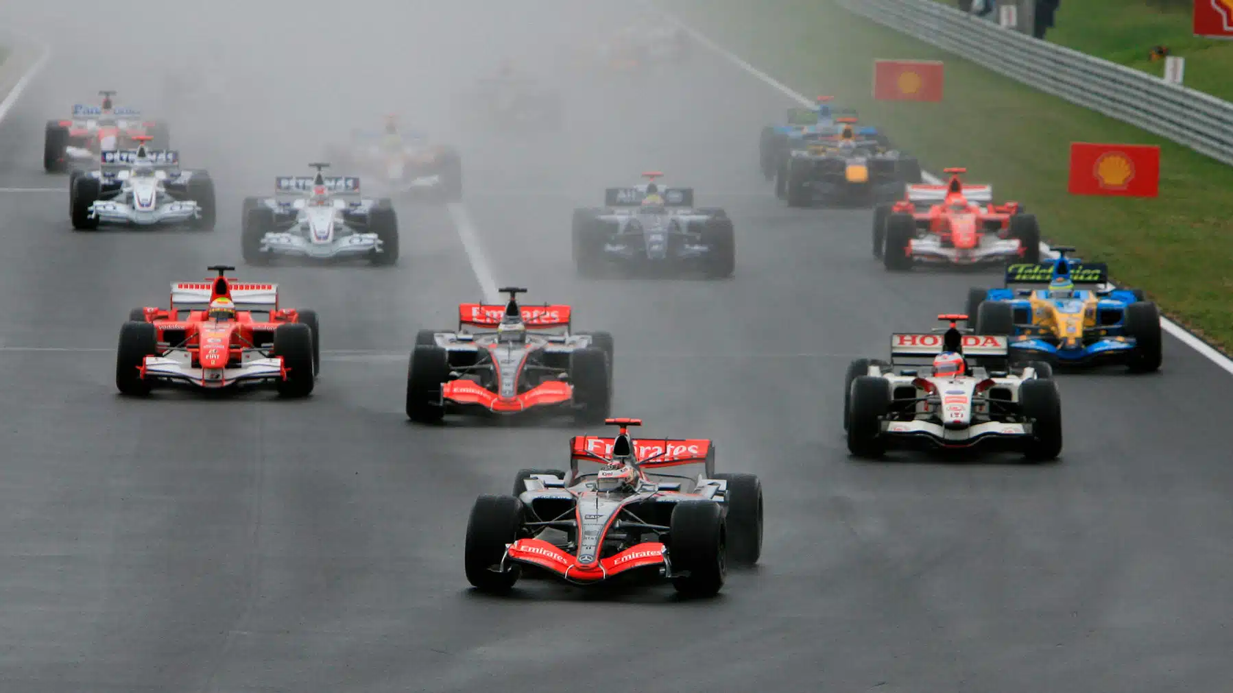 Kimi Raikkonen (McLaren-Mercedes) leads the fueld in the first corner of the wet 2006 Hungarian Grand Prix
