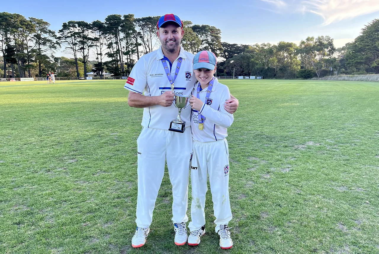 Sam Field and his father holding a cricket trophy