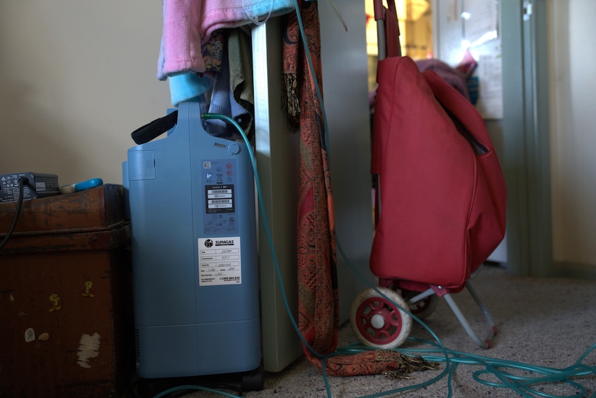 An oxygen tank in a cluttered apartment