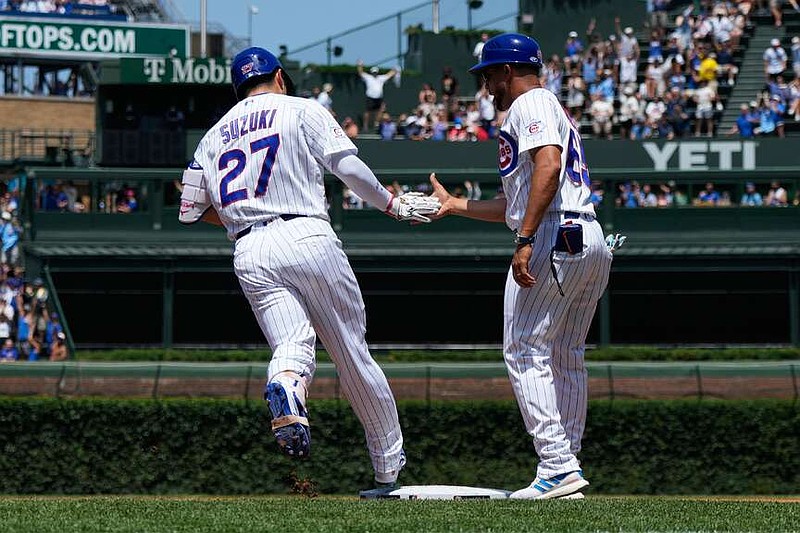 Chicago Cubs' Seiya Suzuki, left, of Japan, celebrates with first base coach Jose Javier after hitting a three-run home run during the first inning of a baseball game against the San Diego Padres in Chicago, Wednesday, July 1, 2026. (AP Photo/Nam Y. Huh)