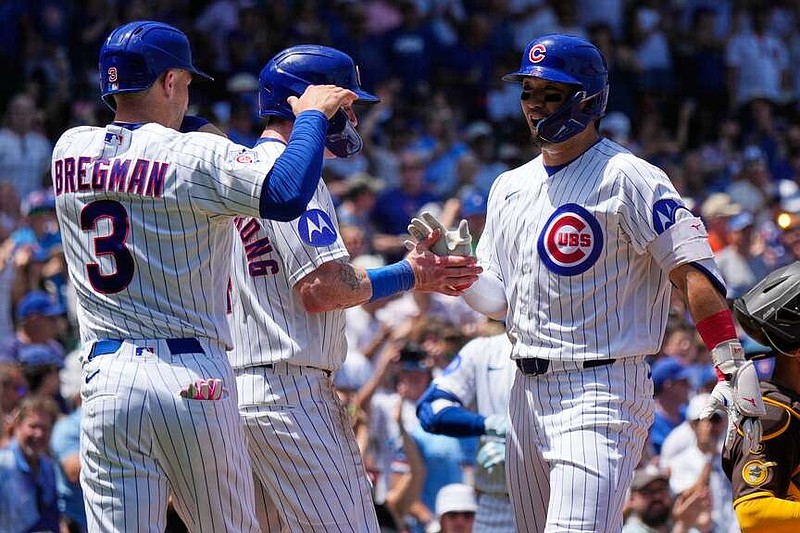 Chicago Cubs' Seiya Suzuki, right, of Japan, celebrates with Alex Bregman, left, and Pete Crow-Armstrong after hitting a three-run home run during the first inning of a baseball game against the San Diego Padres in Chicago, Wednesday, July 1, 2026. (AP Photo/Nam Y. Huh)