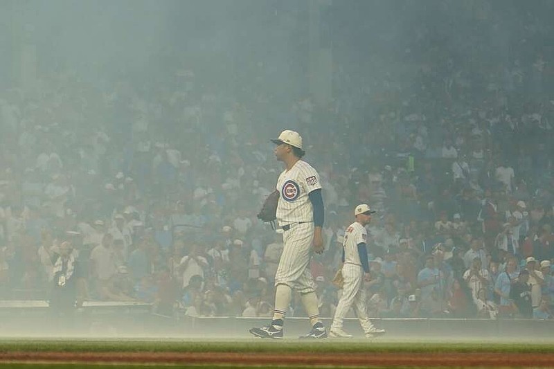 Chicago Cubs pitcher Shota Imanaga stands amidst smoke after fireworks before a baseball game against the St. Louis Cardinals, Saturday, July 4, 2026, in Chicago. (AP Photo/David Banks)