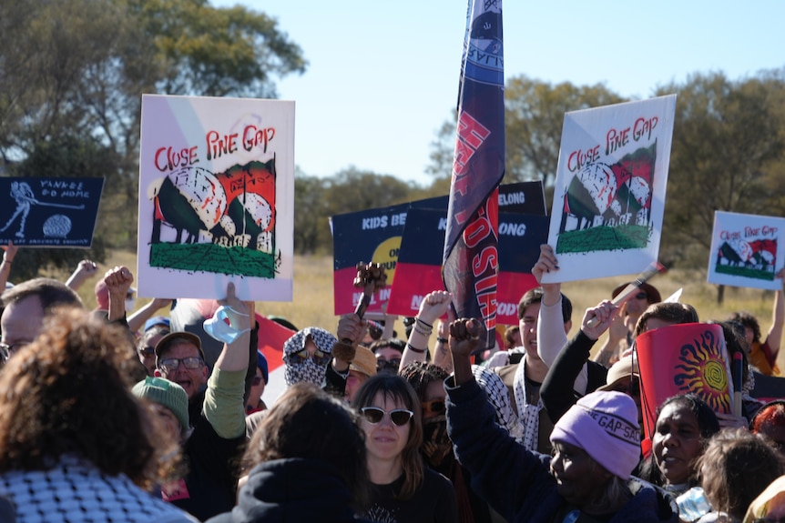Protesters carried signs, placards and flags as they marched towards the site. 