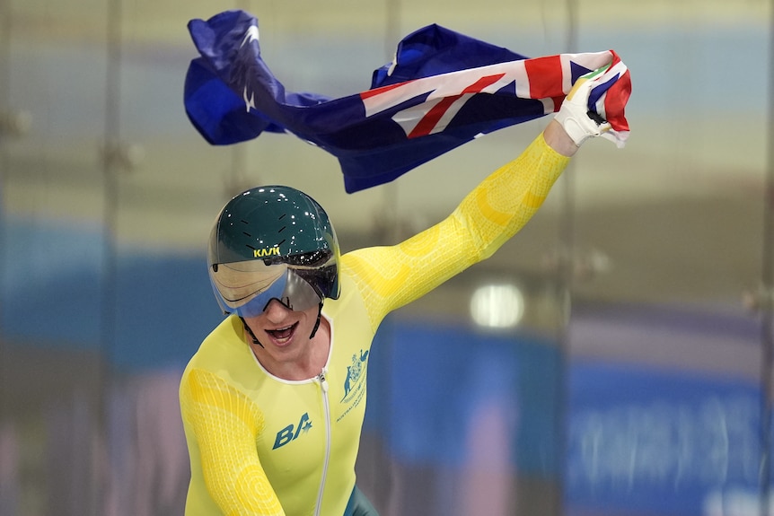 Korey Boddington holds up an Australian flag