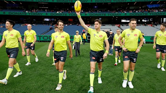 Matt Stevic holds the ball aloft as he enters the ground in game 500.