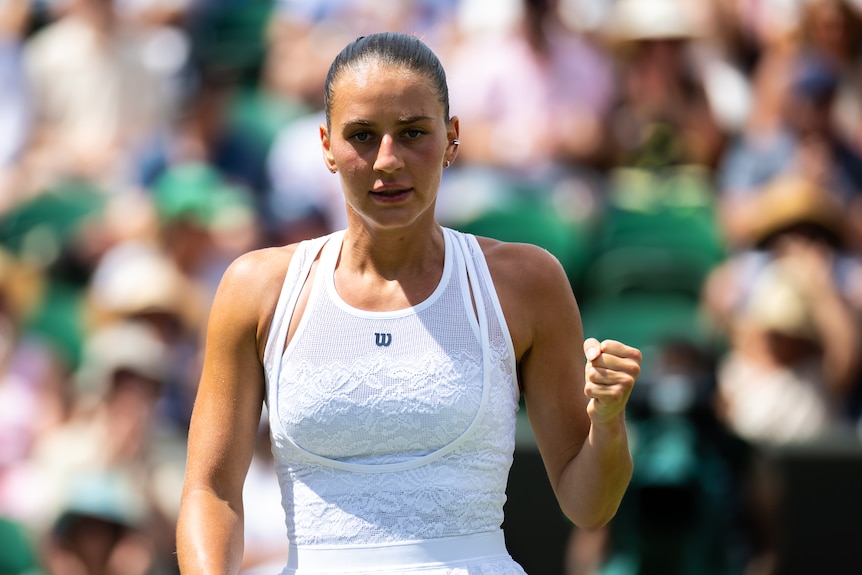 Marta Kostyuk clenches her fist after winning a point at Wimbledon.