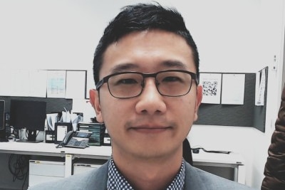 A close up of a man wearing glasses and a suit
