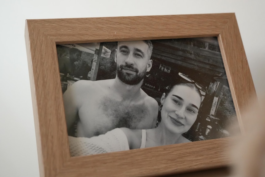picture of framed black and white photo of a shirtless man and a woman