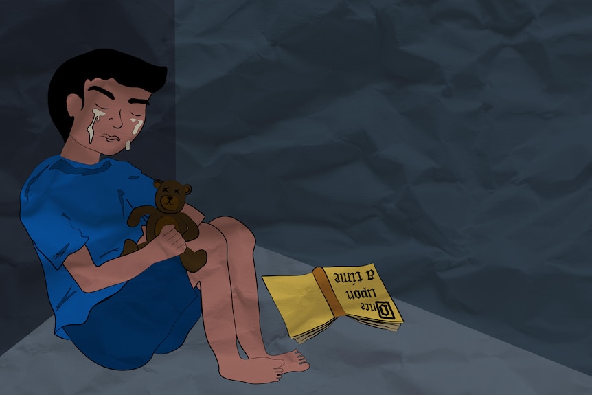 Tears run down a young boy's face as he hold a teddy
