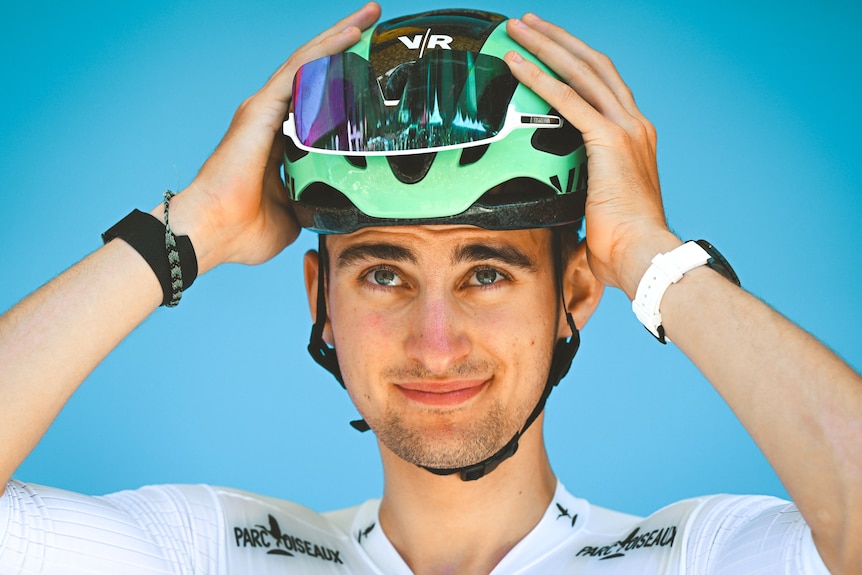 Paul Seixas adjusts his helmet.