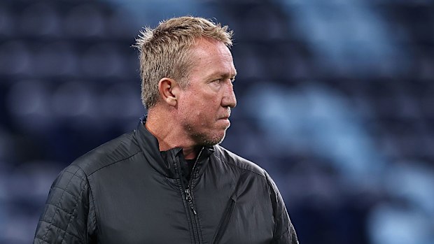 Roosters coach Trent Robinson watches Brumbies players warm up.