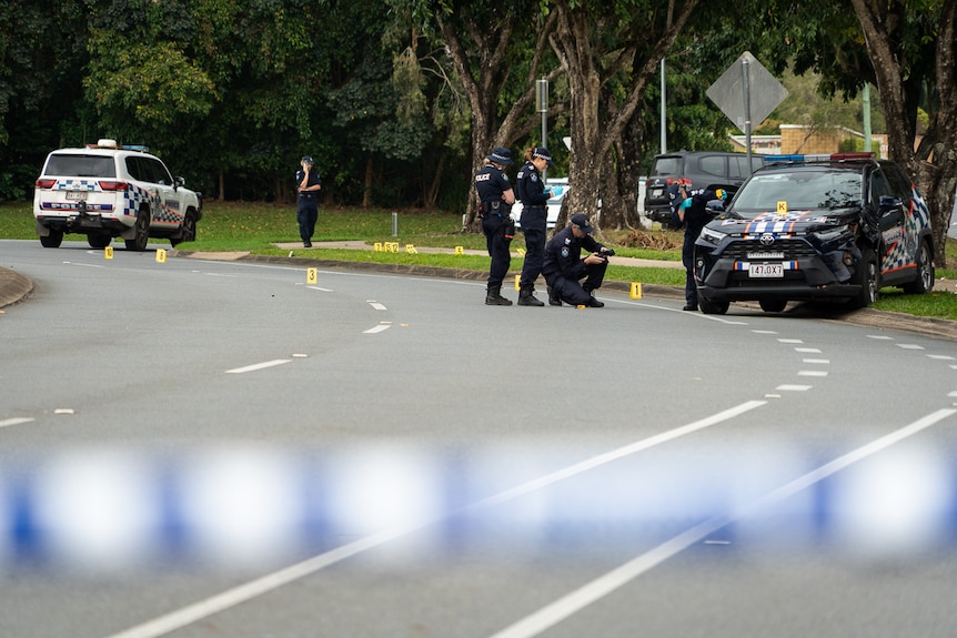 police investigators looking the road on residential street