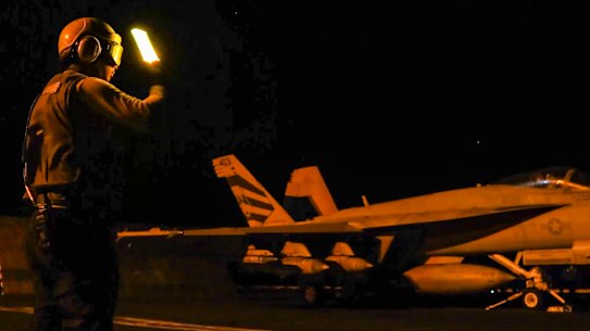 A US fighter jet prepares to launch amid a fresh wave of attacks n Iranian targets.