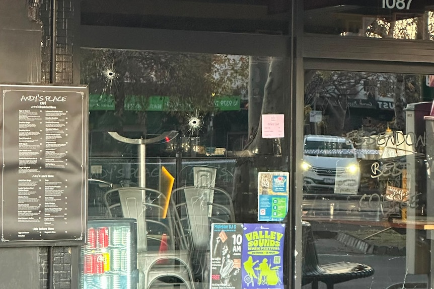 Bullet holes in a window.