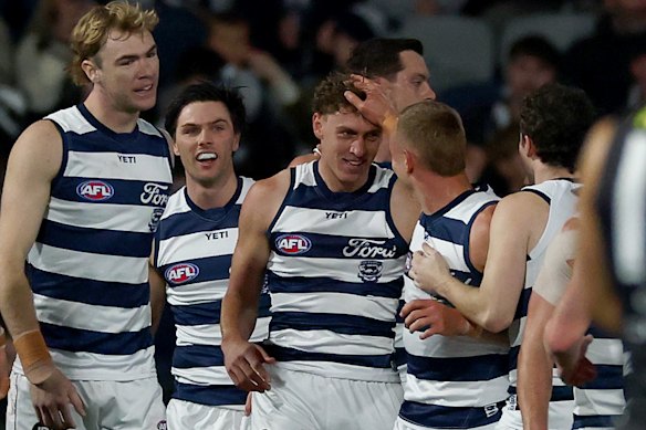 Jay Polkinghorne of the Cats celebrates kicking a goal.