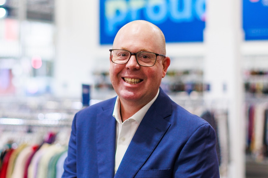 Man in glasses and blue suit.