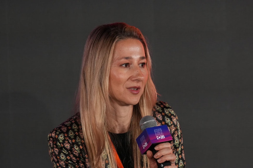 Woman holding microphone.