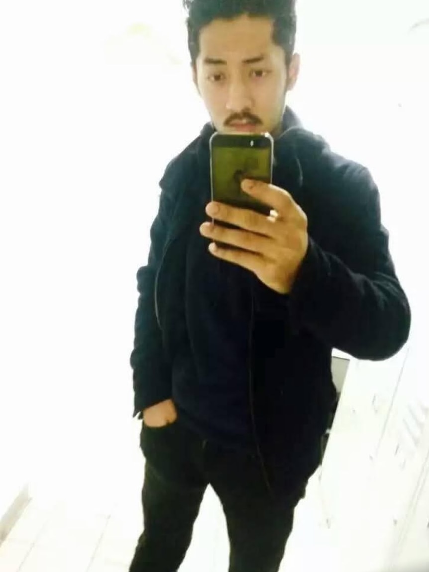 Bikram Lama taking a mirror selfie with phone