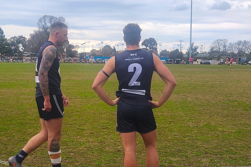 Two football players wearing black armbands