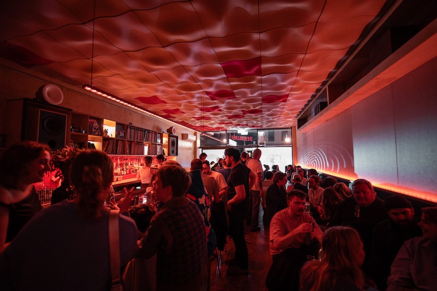people inside a dark small bar called deadwax in enmore in sydney