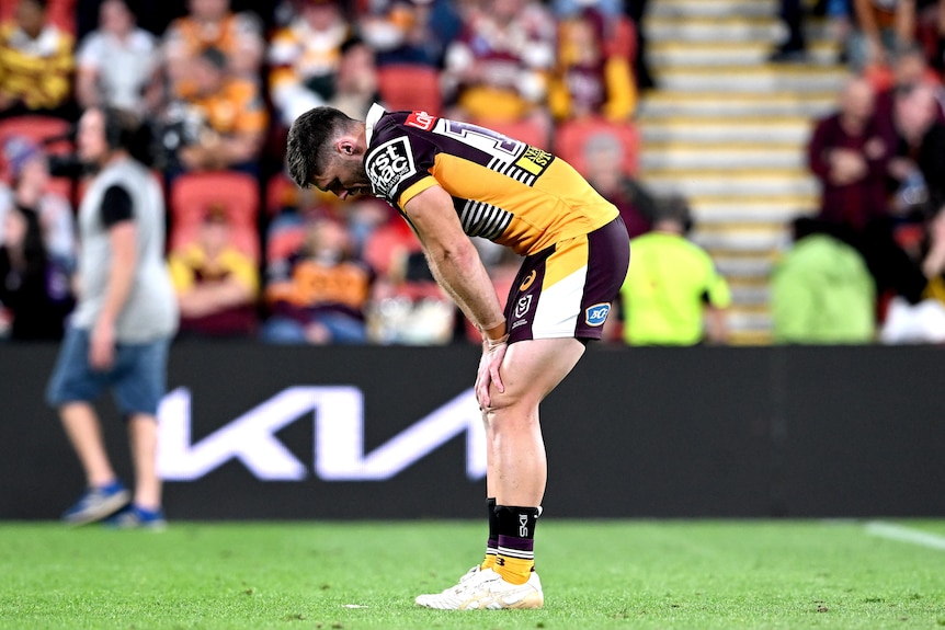 Brisbane Broncos player Corey Jensen leans over during an NRL game against the Melbourne Storm.