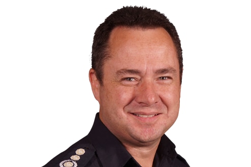A headshot of a man with short brown hair, wearing dark navy CFA uniform, smiling