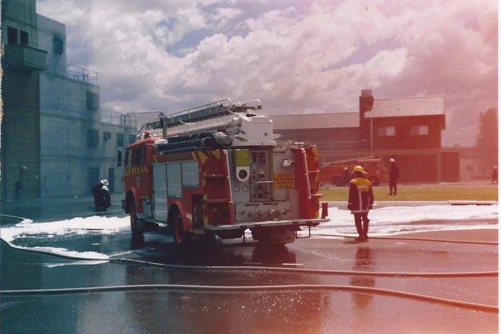 A fire truck parked on tarmac.