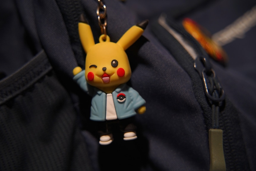 A small pikachu toy attached to a backpack