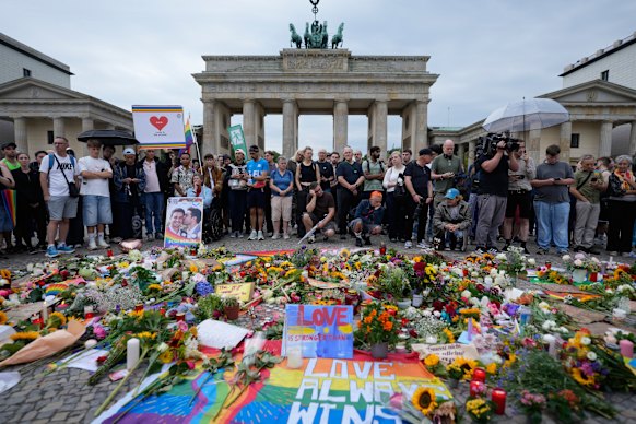 People gather near the Brandenburg Gate supporting the LGBTQ community after the Pride March attack.
