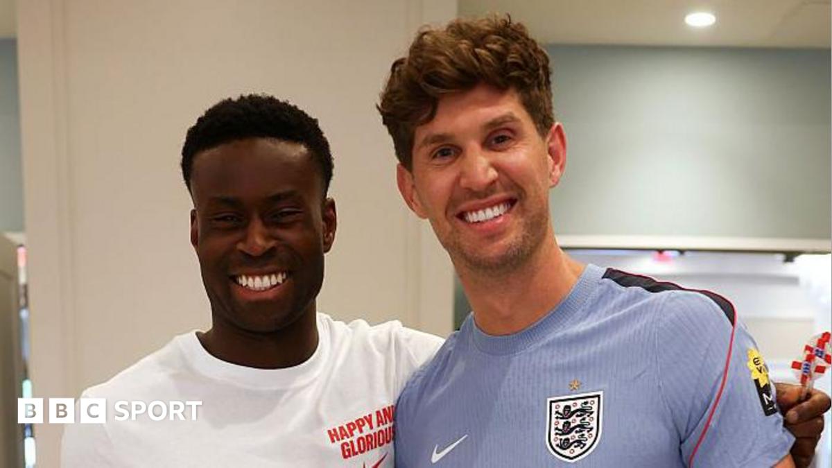 A picture of Guehi and Stones smiling at the camera at England's training camp in Kansas City