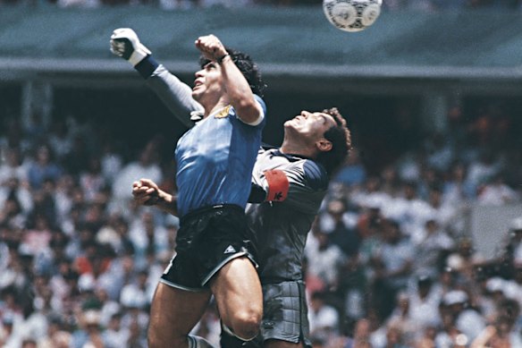 Diego Maradona punches the ball into the net for his “Hand of God” goal against England in 1986.