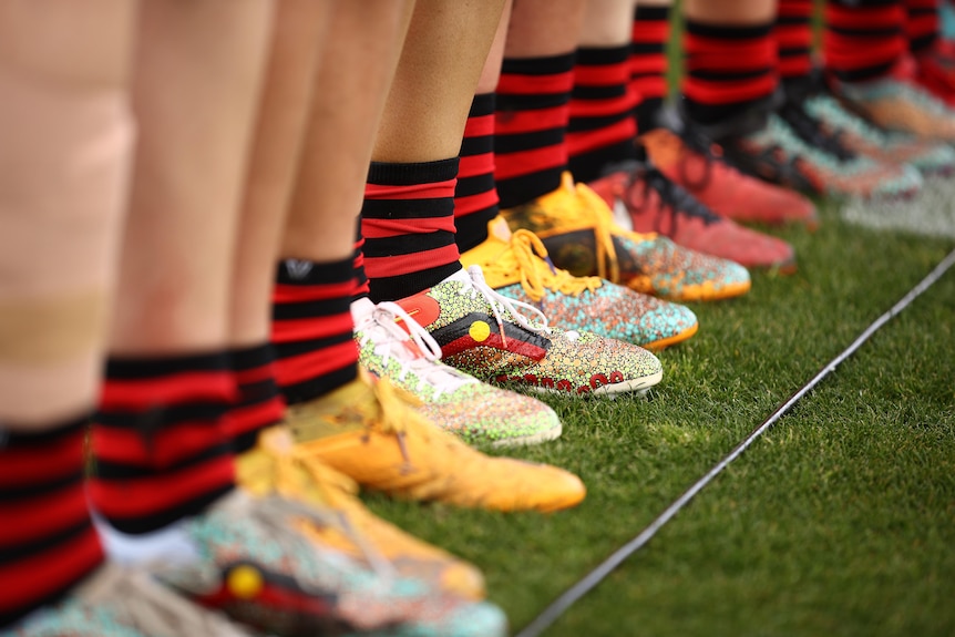 Bombers players wear indigenous designed boots during the round four AFLW match.