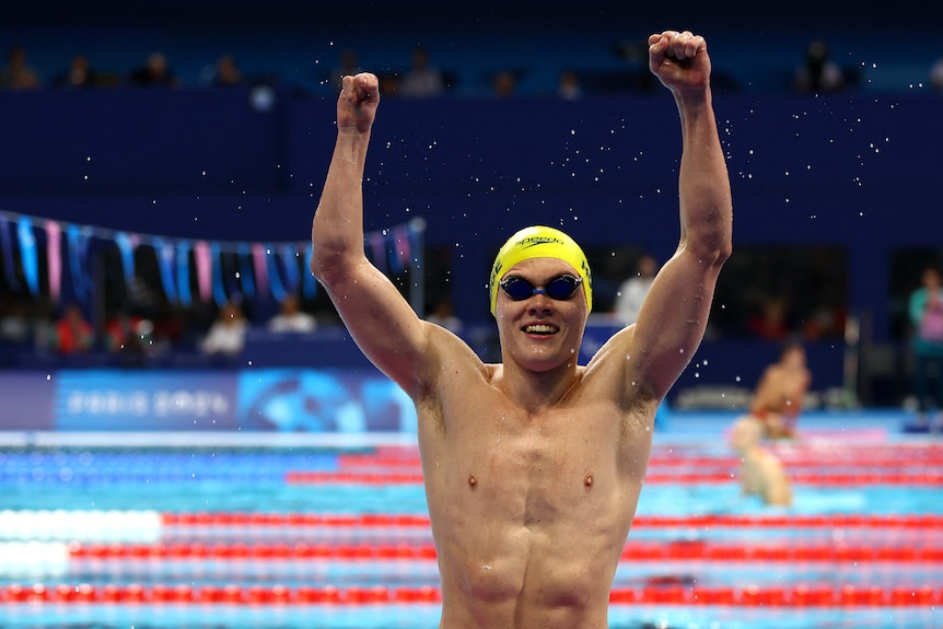 Timothy Hodge of Australia celebrates after winning the gold, raising his arms in triumph 