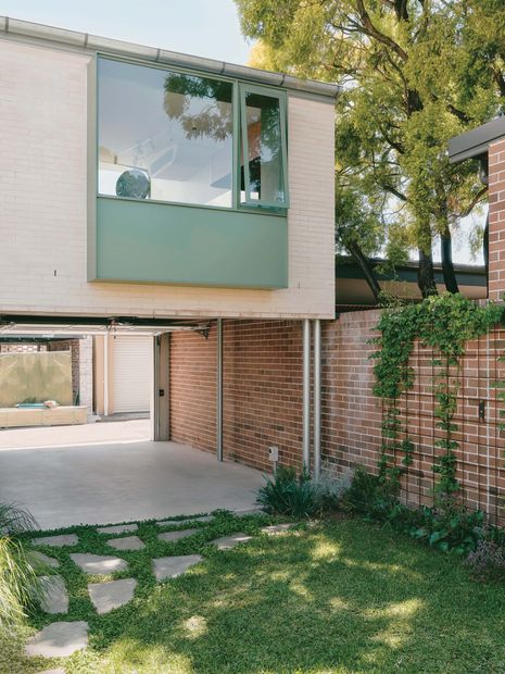 The garage remains open to the garden, allowing it to function as a flexible outdoor room.