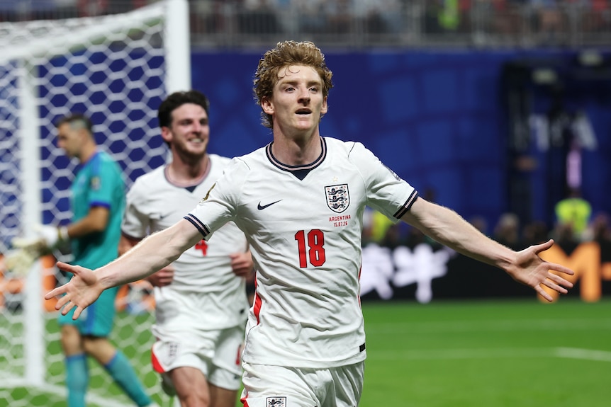 Anthony Gordon runs off with his arms outstretched in celebration