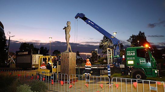 PERTH, AUSTRALIA - JULY 05: The statue of former AFL player Nicky Winmar is removed from outside of Optus Stadium on July 05, 2026 in Perth, Australia. Winmar was last week found guilty of assault in a Victorian Court. (Photo by Paul Kane/Getty Images)