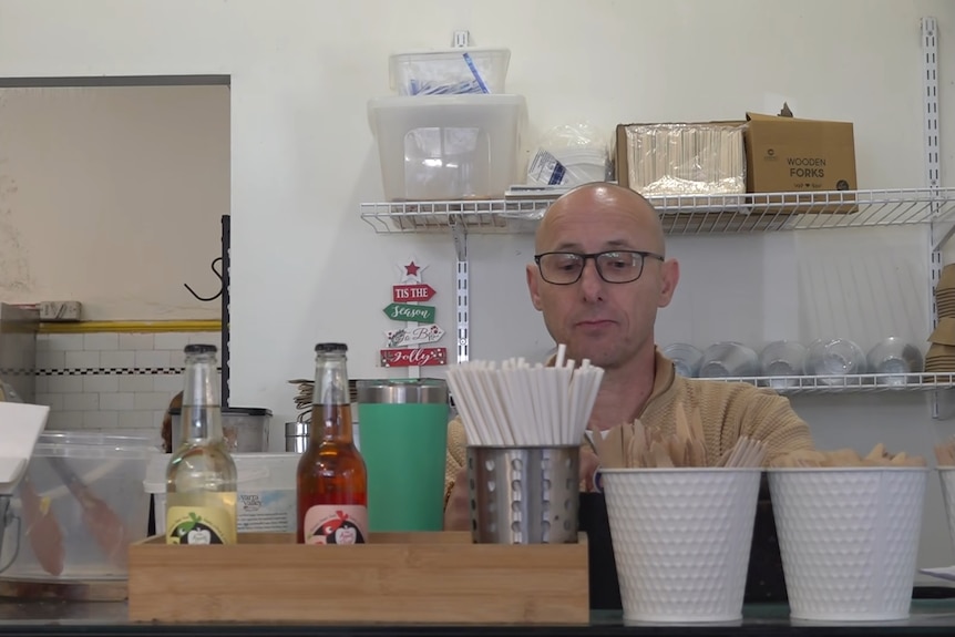 Man working behind a cafe counter