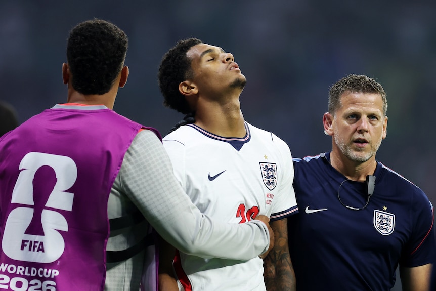 Jarrell Quansah looks disappointed as he walks off the pitch after his red card