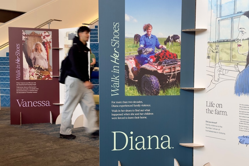 A man walks through exhibits at the Walk in Her Shoes exhibition in Box Hill.