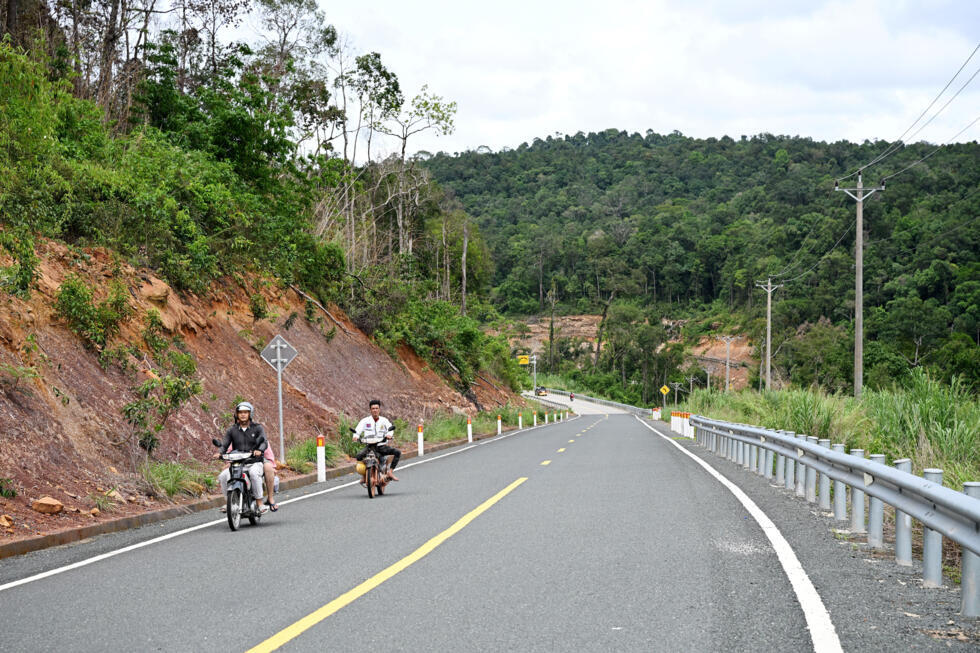 Motorists on a road in the Cardamom National Park in Koh Kong province